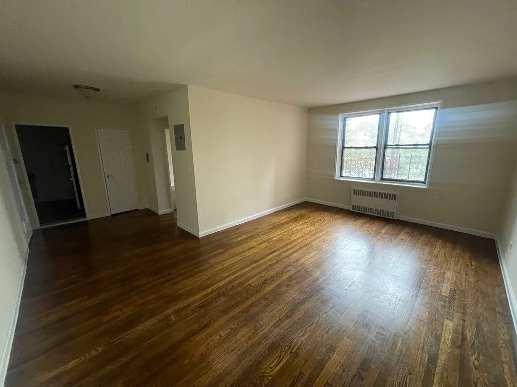 apartment listing photo of an empty room with window