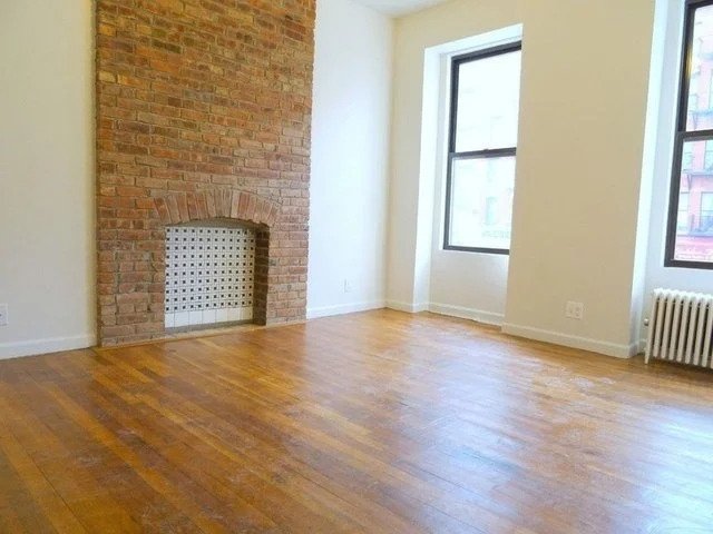 living room with brick fireplace