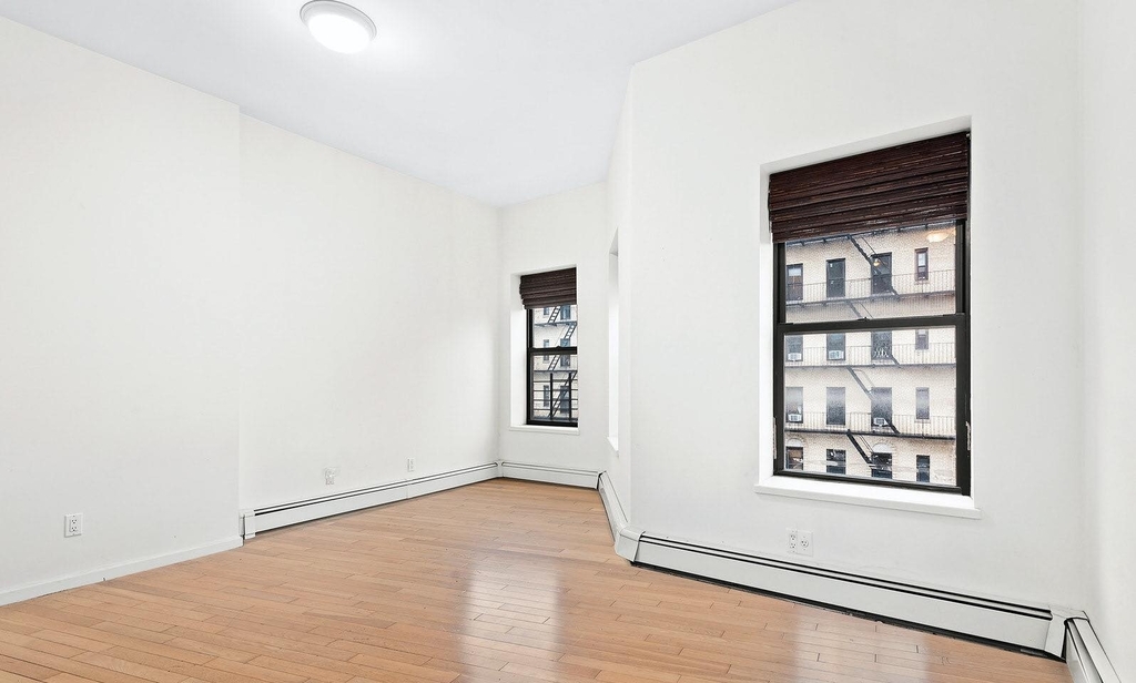 photo of large bedroom with two windows