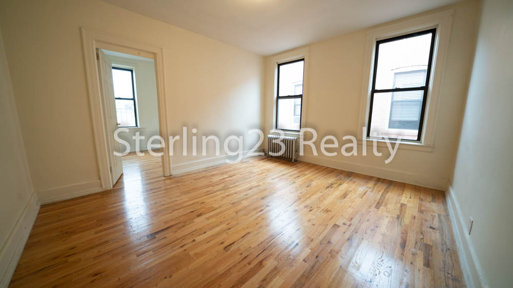 brightly lit room with two windows