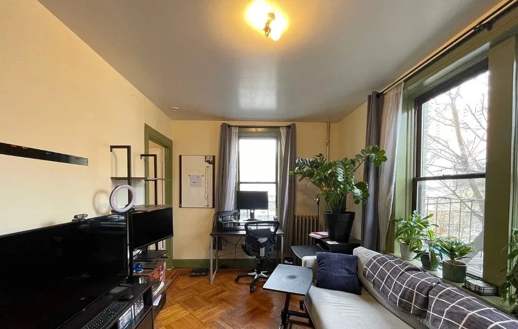 Brooklyn apartment with a living room with large windows in January 2023