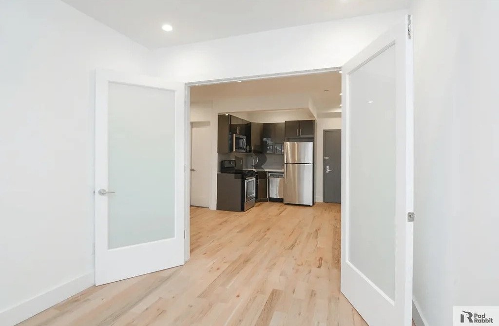 bright bedroom opening into kitchen