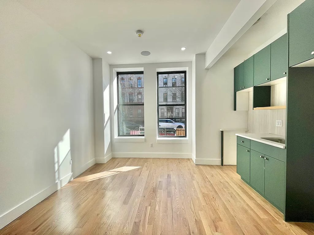Kitchen with green cabinetry