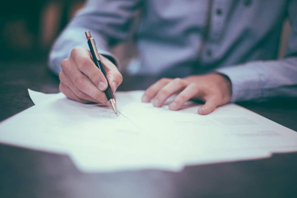Man signing pieces of paper